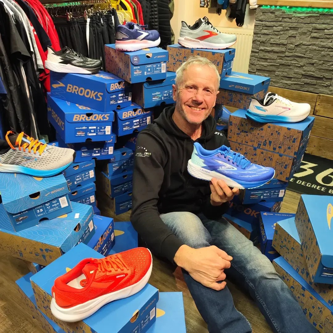 Christian Zoss umgeben von den neuesten Laufschuhmodellen